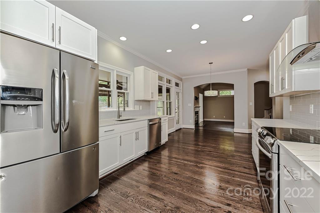 9528 Millen Drive Harrisburg, NC 28075 - Photo 16 of 48 a kitchen with stainless steel appliances a refrigerator and a stove top oven