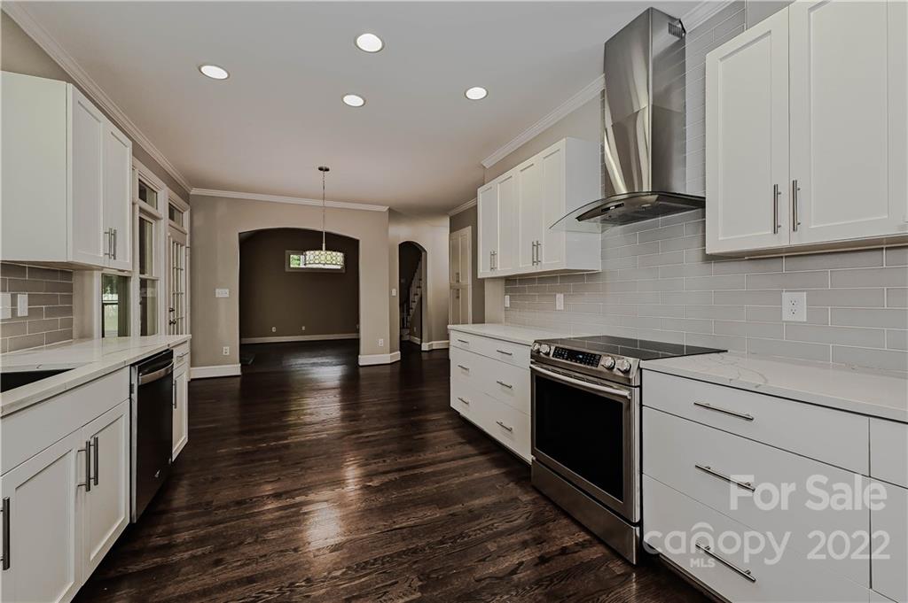 9528 Millen Drive Harrisburg, NC 28075 - Photo 17 of 48 a kitchen with stainless steel appliances granite countertop a stove and a refrigerator