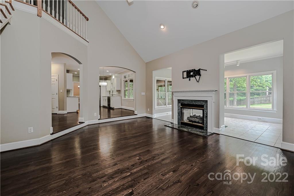 9528 Millen Drive Harrisburg, NC 28075 - Photo 20 of 48 a view of a livingroom with wooden floor and a fireplace