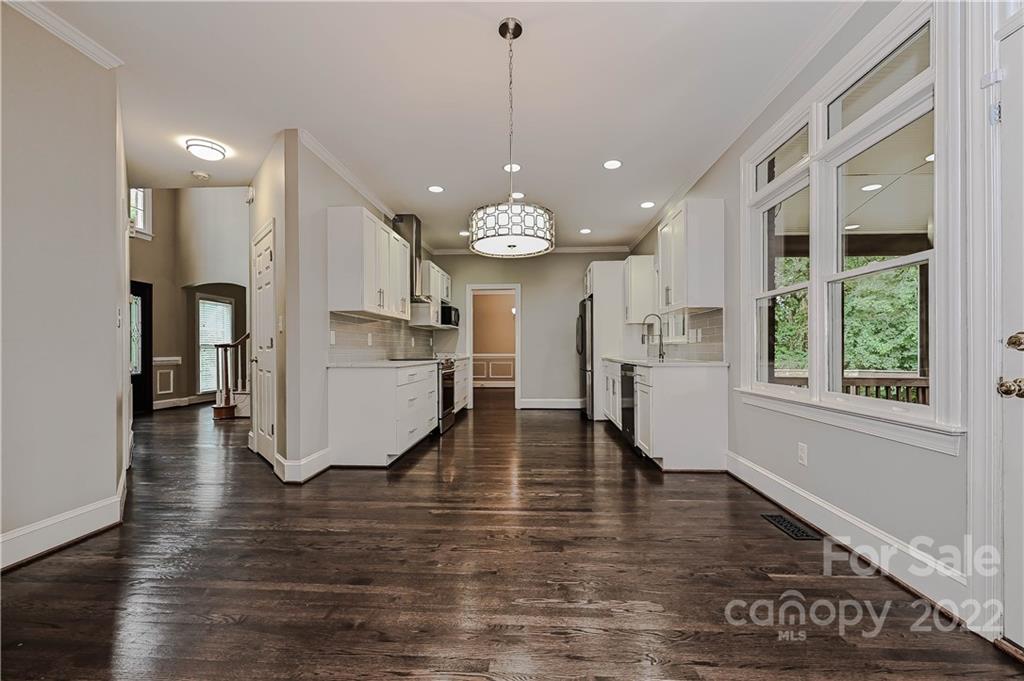 9528 Millen Drive Harrisburg, NC 28075 - Photo 26 of 48 a view of a kitchen and dining room with wooden floor