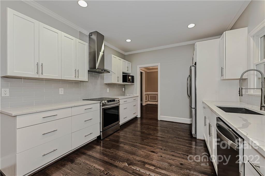 9528 Millen Drive Harrisburg, NC 28075 - Photo 29 of 48 a kitchen with stainless steel appliances granite countertop a sink stove and refrigerator