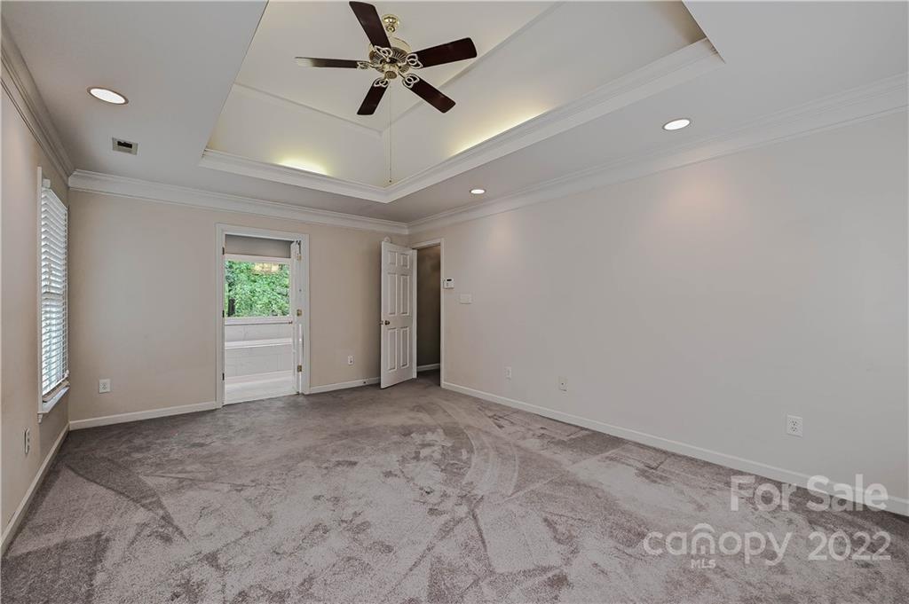 9528 Millen Drive Harrisburg, NC 28075 - Photo 32 of 48 an empty room with a empty space and a ceiling fan