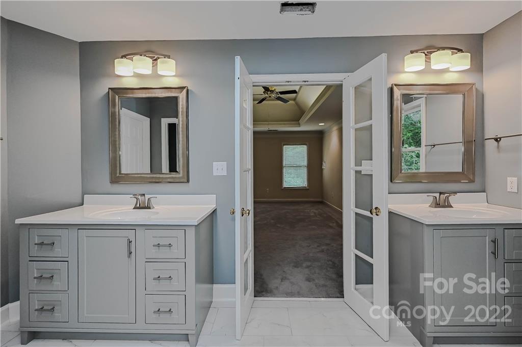 9528 Millen Drive Harrisburg, NC 28075 - Photo 34 of 48 a bathroom with a sink and a mirror