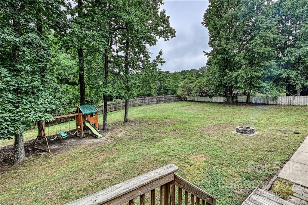 9528 Millen Drive Harrisburg, NC 28075 - Photo 45 of 48 a view of a bench in the garden
