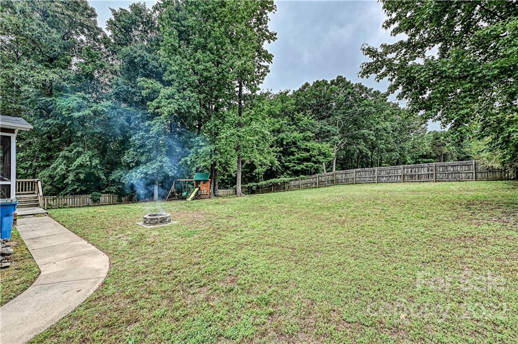 9528 Millen Drive Harrisburg, NC 28075 - Photo 46 of 48 a view of a field with trees in the background