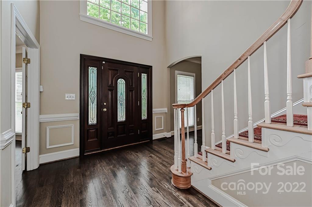 9528 Millen Drive Harrisburg, NC 28075 - Photo 5 of 48 a view of front door with wooden floor and stairs