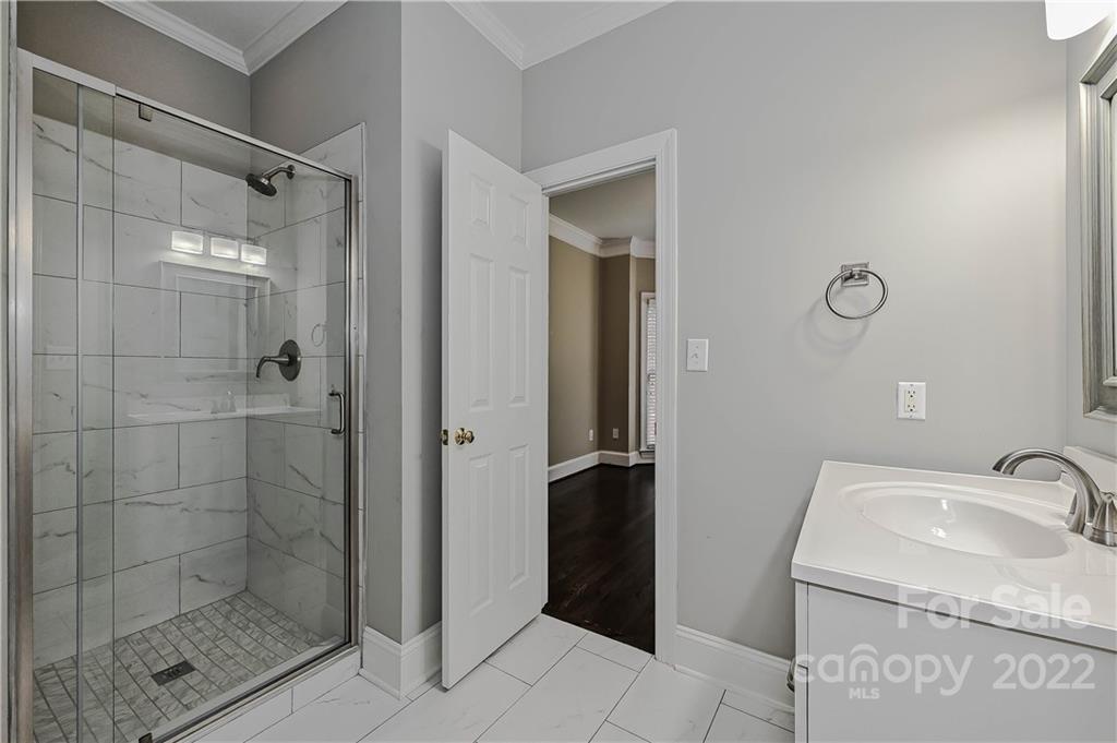9528 Millen Drive Harrisburg, NC 28075 - Photo 8 of 48 a bathroom with a granite countertop sink mirror and shower