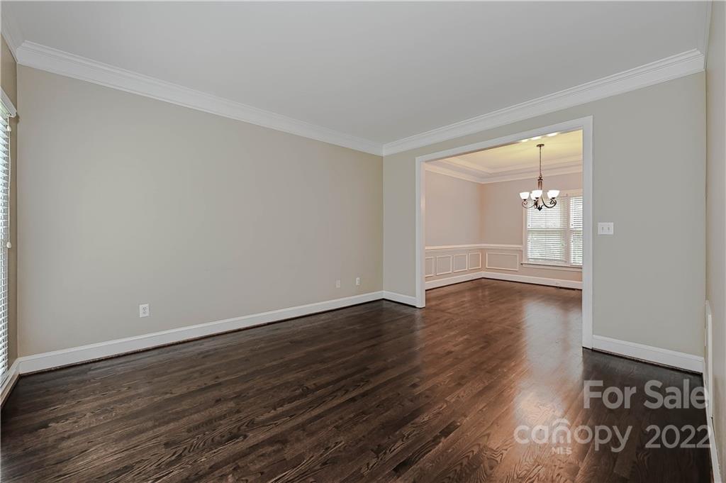 9528 Millen Drive Harrisburg, NC 28075 - Photo 10 of 48 a view of an empty room with wooden floor and a window