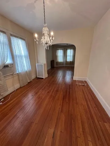 a view of a livingroom with wooden floor and staircase