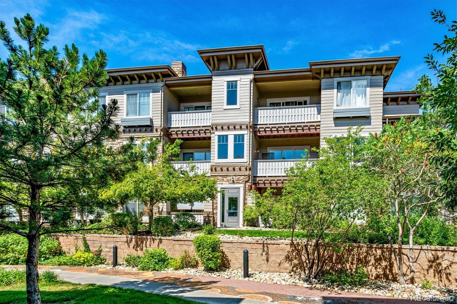a front view of a building with trees