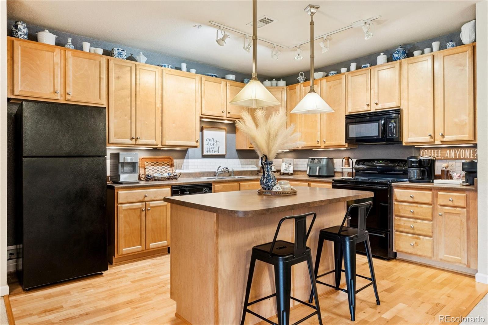 9370 Las Ramblas Court, Unit R Parker, CO 80134 - Photo 14 of 39 a kitchen with a refrigerator a stove a sink and dishwasher with wooden floor