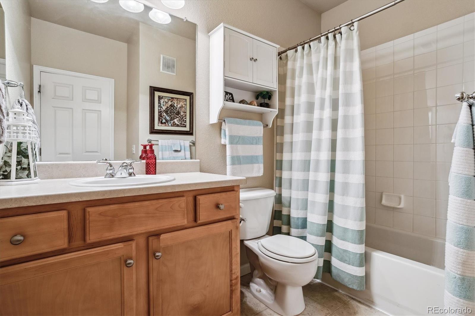 9370 Las Ramblas Court, Unit R Parker, CO 80134 - Photo 19 of 39 a bathroom with a sink toilet vanity and shower