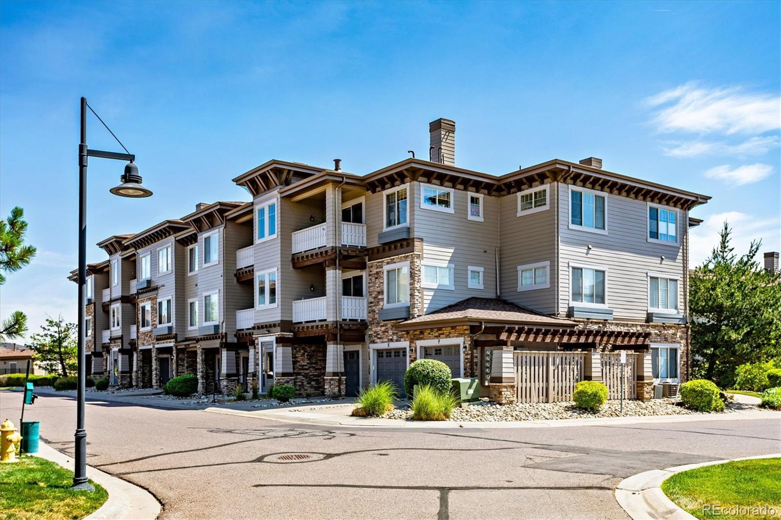 9370 Las Ramblas Court, Unit R Parker, CO 80134 - Photo 2 of 39 a front view of a building with street