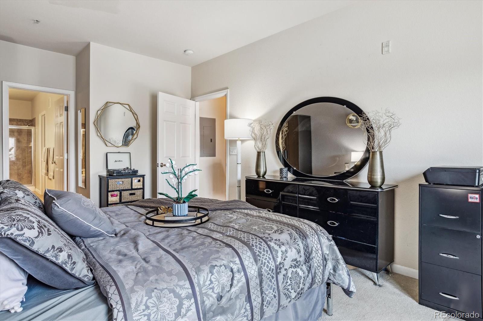 9370 Las Ramblas Court, Unit R Parker, CO 80134 - Photo 24 of 39 a bedroom with a bed and a dresser