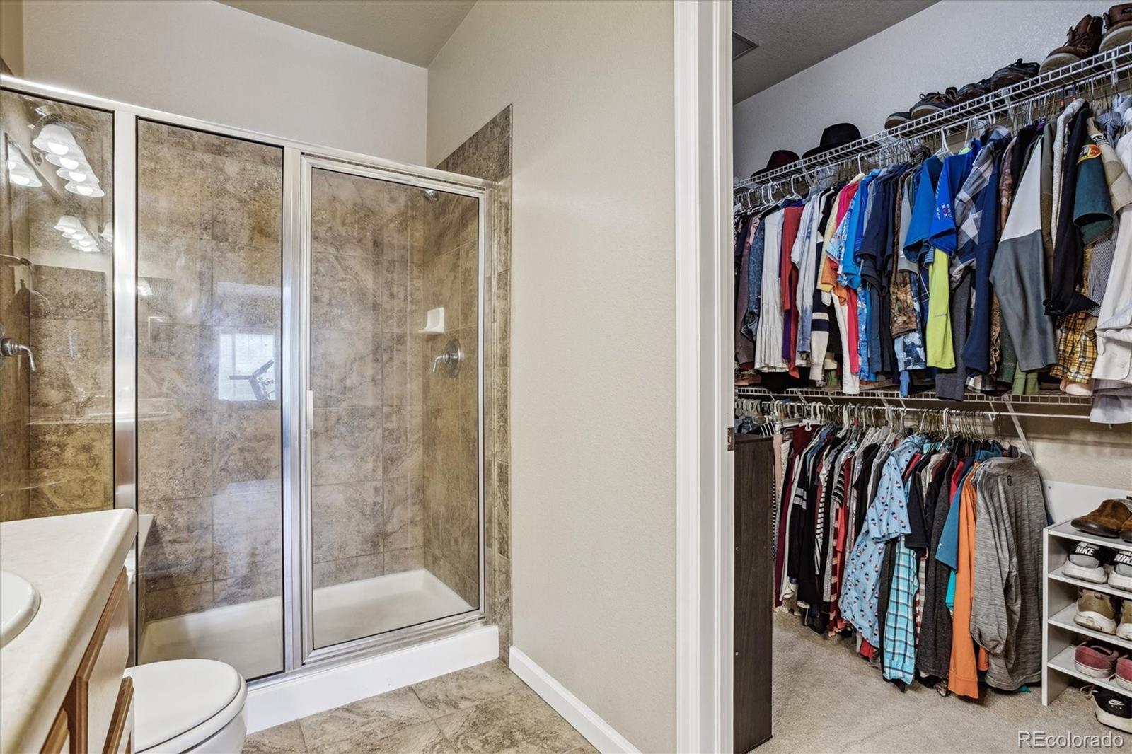 9370 Las Ramblas Court, Unit R Parker, CO 80134 - Photo 27 of 39 a view of walk in closet with clothes