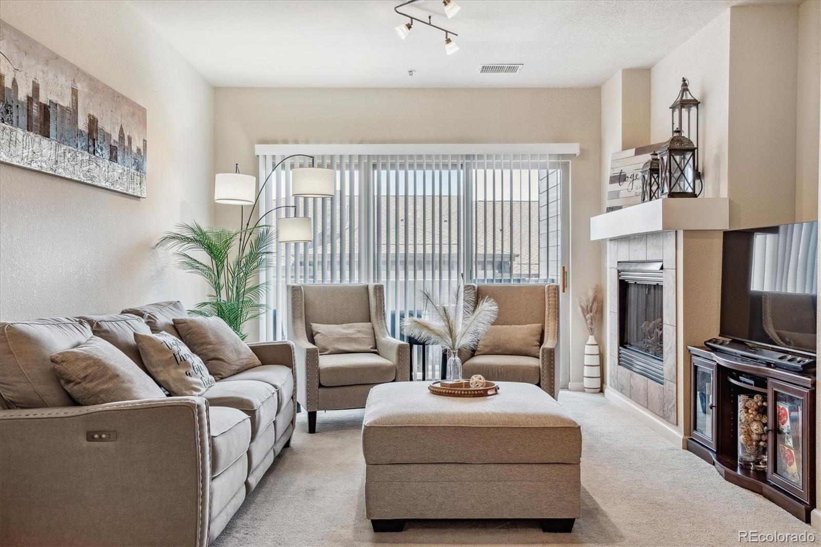 9370 Las Ramblas Court, Unit R Parker, CO 80134 - Photo 34 of 39 a living room with furniture fireplace and flat screen tv