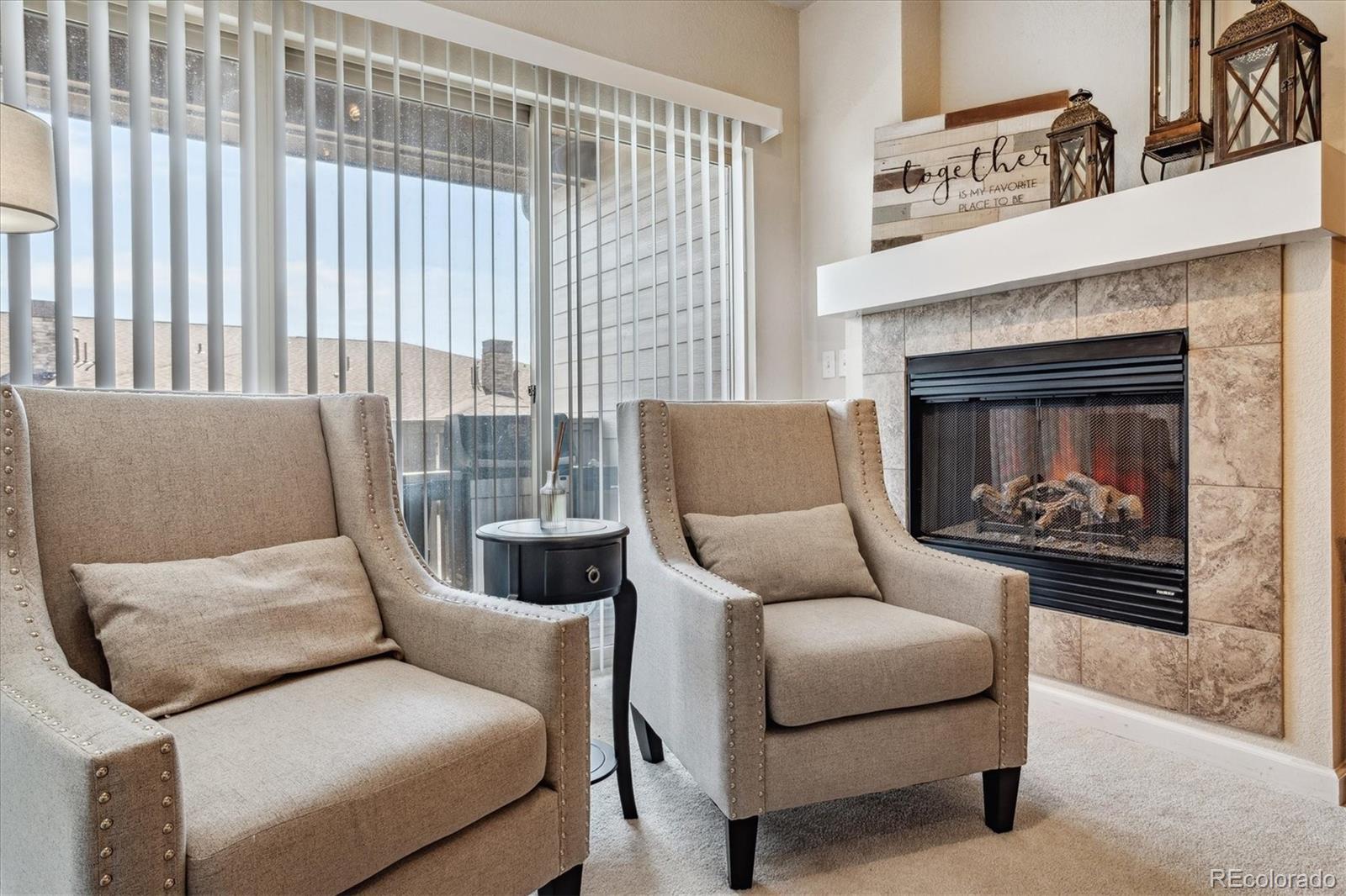 9370 Las Ramblas Court, Unit R Parker, CO 80134 - Photo 35 of 39 a living room with furniture and a fireplace