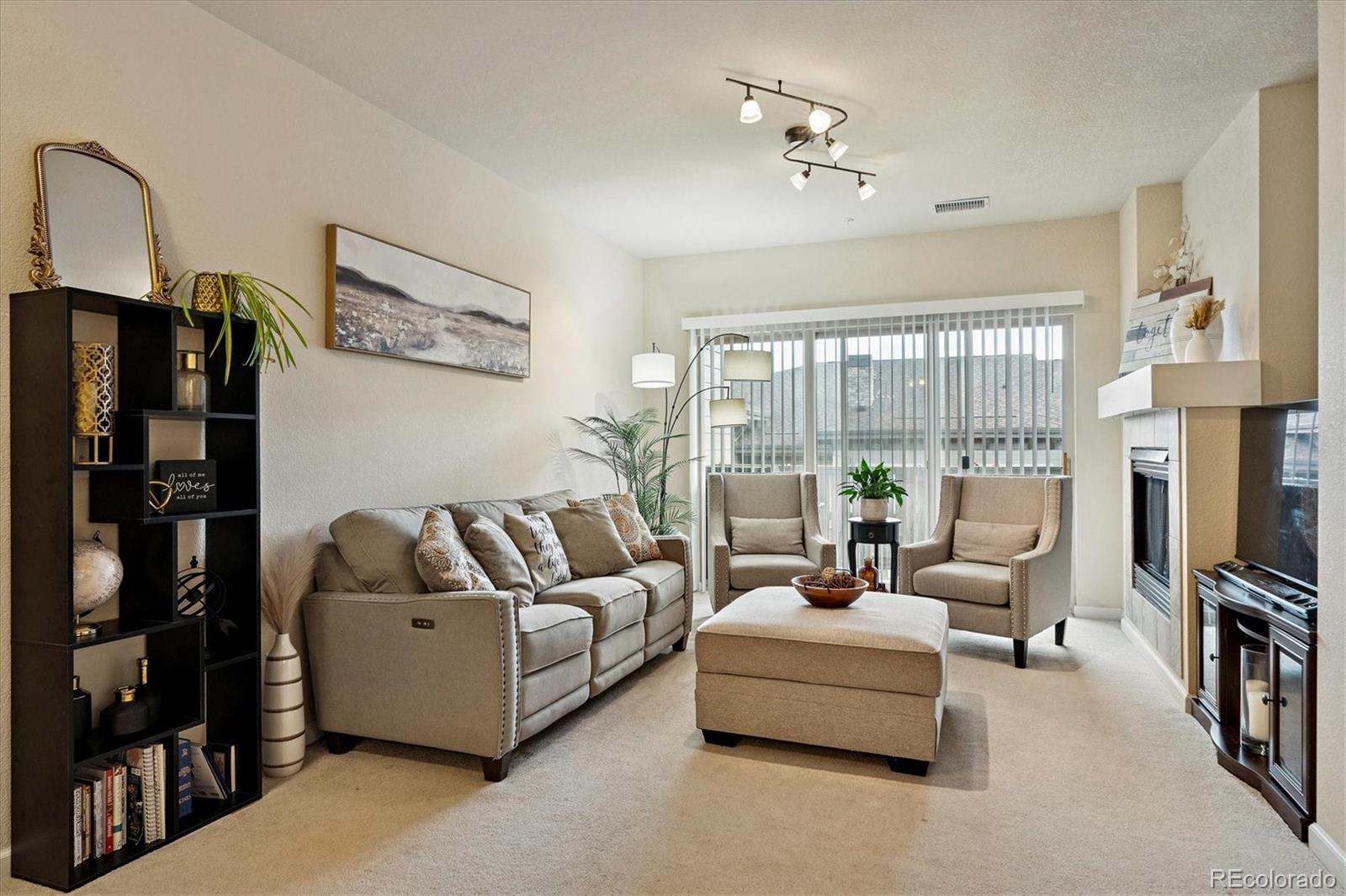 9370 Las Ramblas Court, Unit R Parker, CO 80134 - Photo 36 of 39 a living room with furniture fireplace and flat screen tv