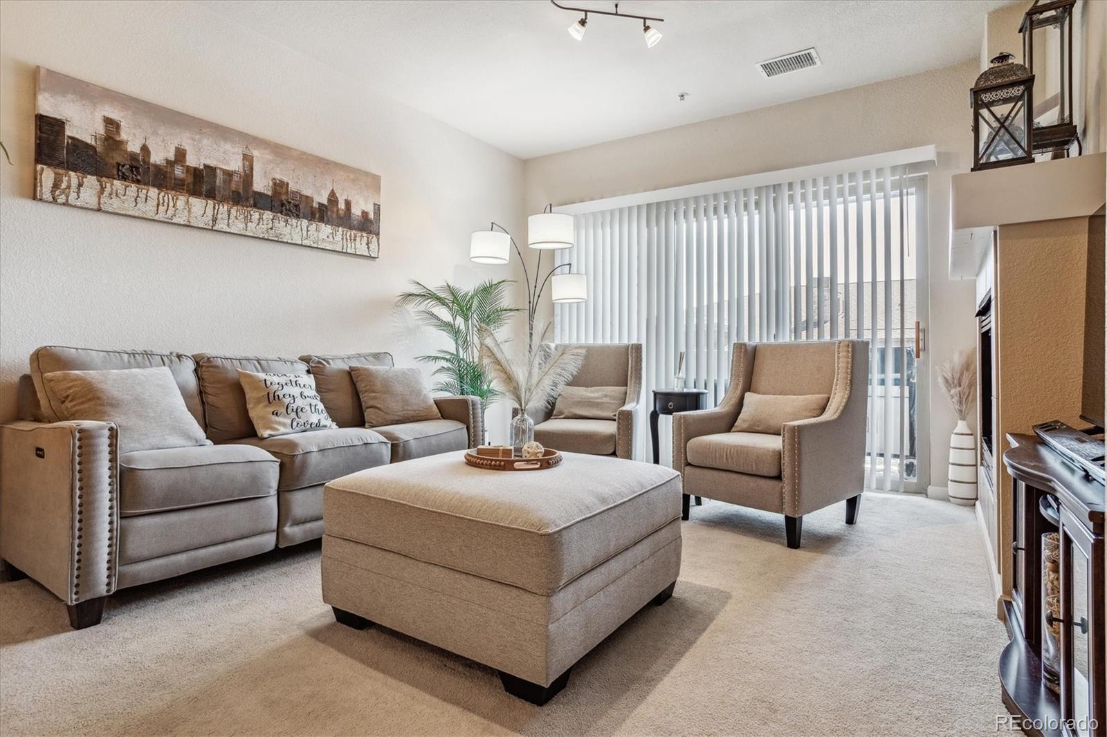 9370 Las Ramblas Court, Unit R Parker, CO 80134 - Photo 5 of 39 a living room with furniture and a flat screen tv