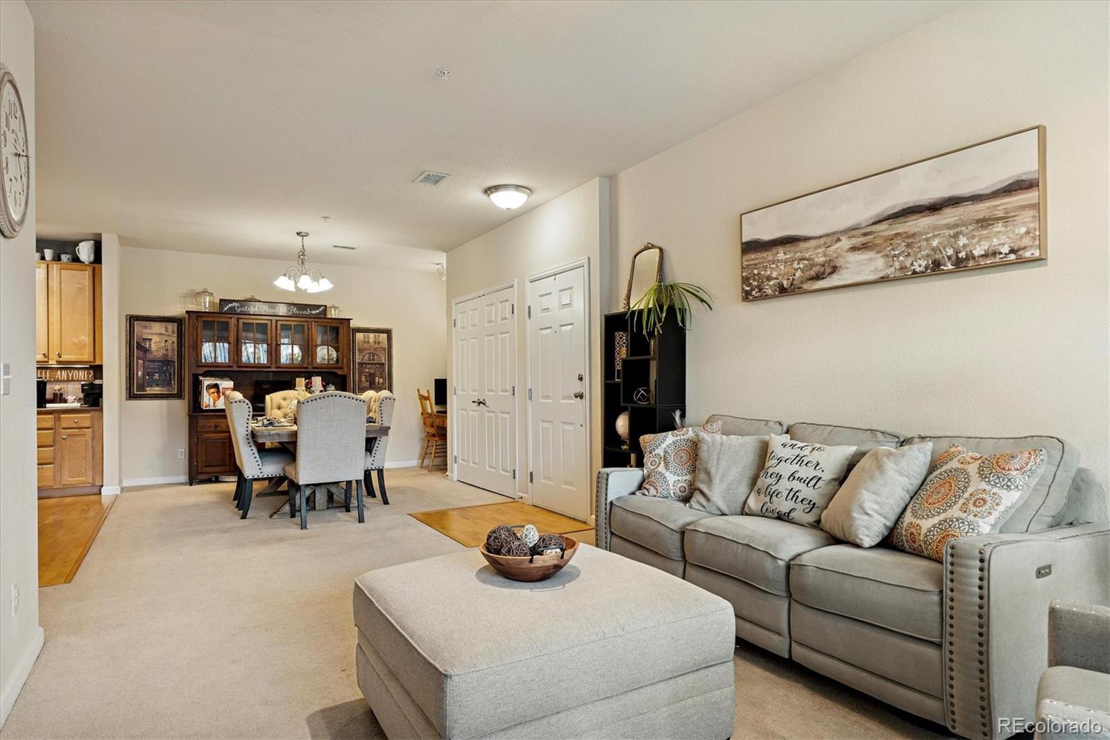 9370 Las Ramblas Court, Unit R Parker, CO 80134 - Photo 8 of 39 a living room with furniture and a chandelier