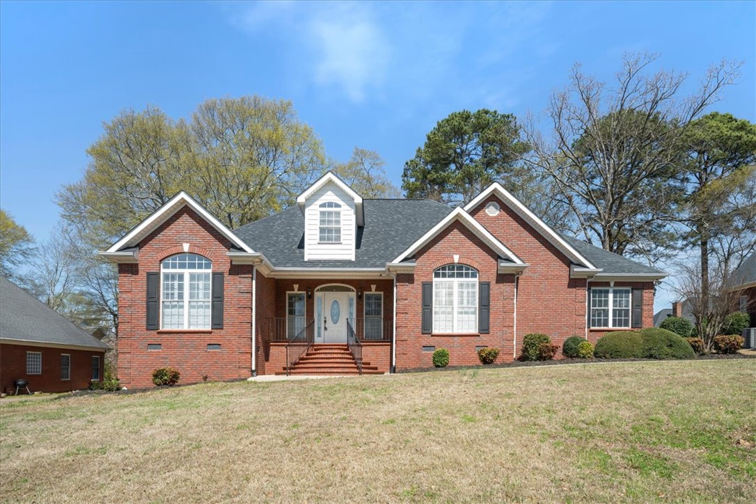 128 Cayman Way Anderson, SC 29621 - Photo 45 of 49 This classic brick residence features an inviting facade and expansive lawn, perfect for outdoor enjoyment.
