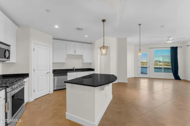 a kitchen with granite countertop a stove and a sink