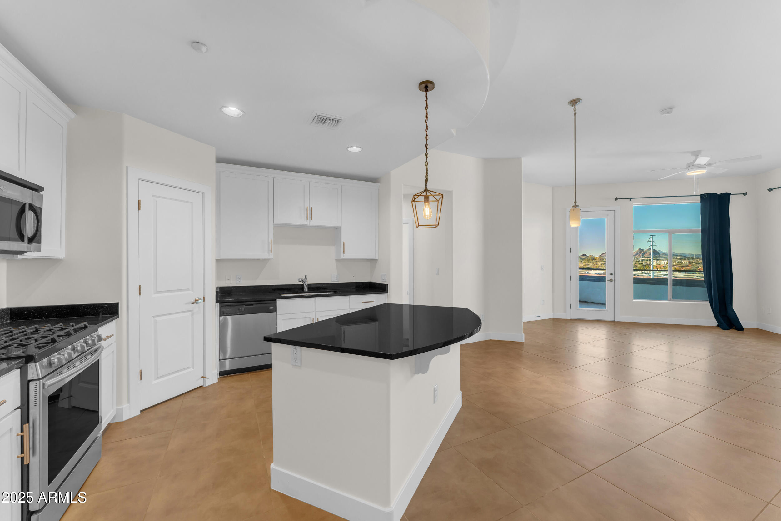 945 East Playa Del Norte Drive, Unit 5005 Tempe, AZ 85288 - Photo 10 of 69 a kitchen with granite countertop a stove and a sink