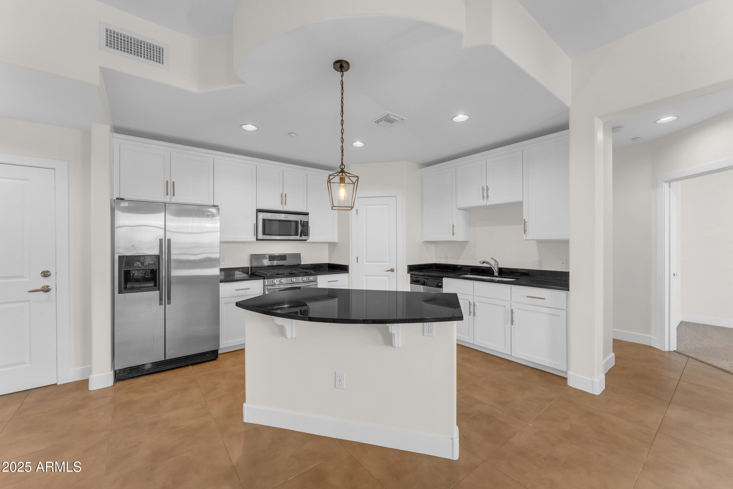945 East Playa Del Norte Drive, Unit 5005 Tempe, AZ 85288 - Photo 12 of 69 a kitchen with stainless steel appliances granite countertop a sink a stove a refrigerator and white cabinets