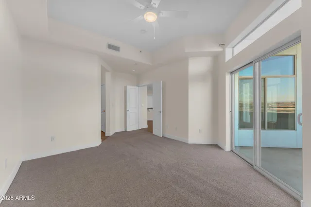 a bedroom with a bed and a potted plant