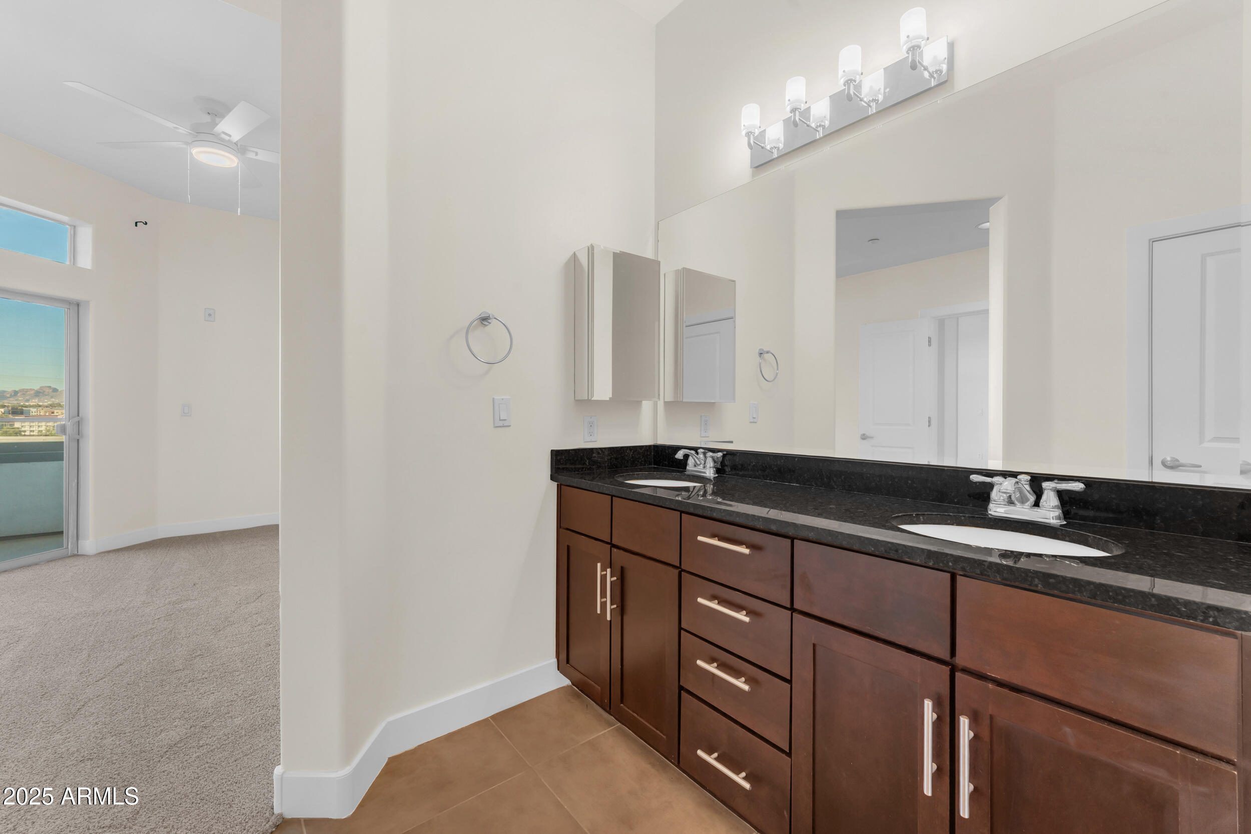945 East Playa Del Norte Drive, Unit 5005 Tempe, AZ 85288 - Photo 29 of 69 a bathroom with a granite countertop sink and a mirror