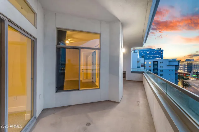 an empty room with closet and a chandelier fan