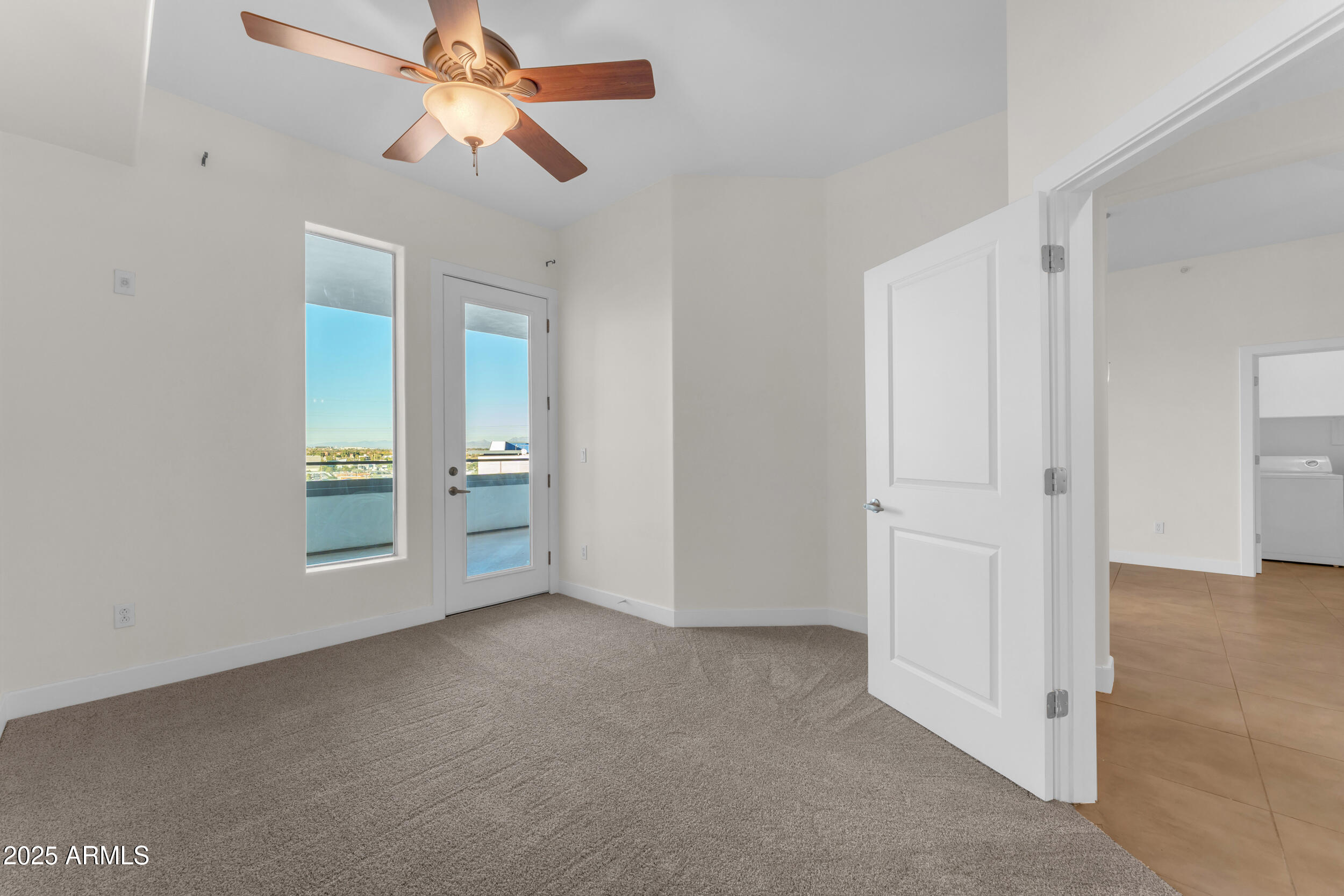 945 East Playa Del Norte Drive, Unit 5005 Tempe, AZ 85288 - Photo 33 of 69 an empty room with closet and a chandelier fan