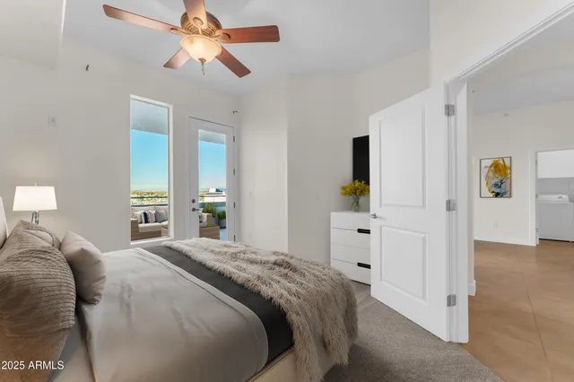a view of an empty room and a chandelier fan