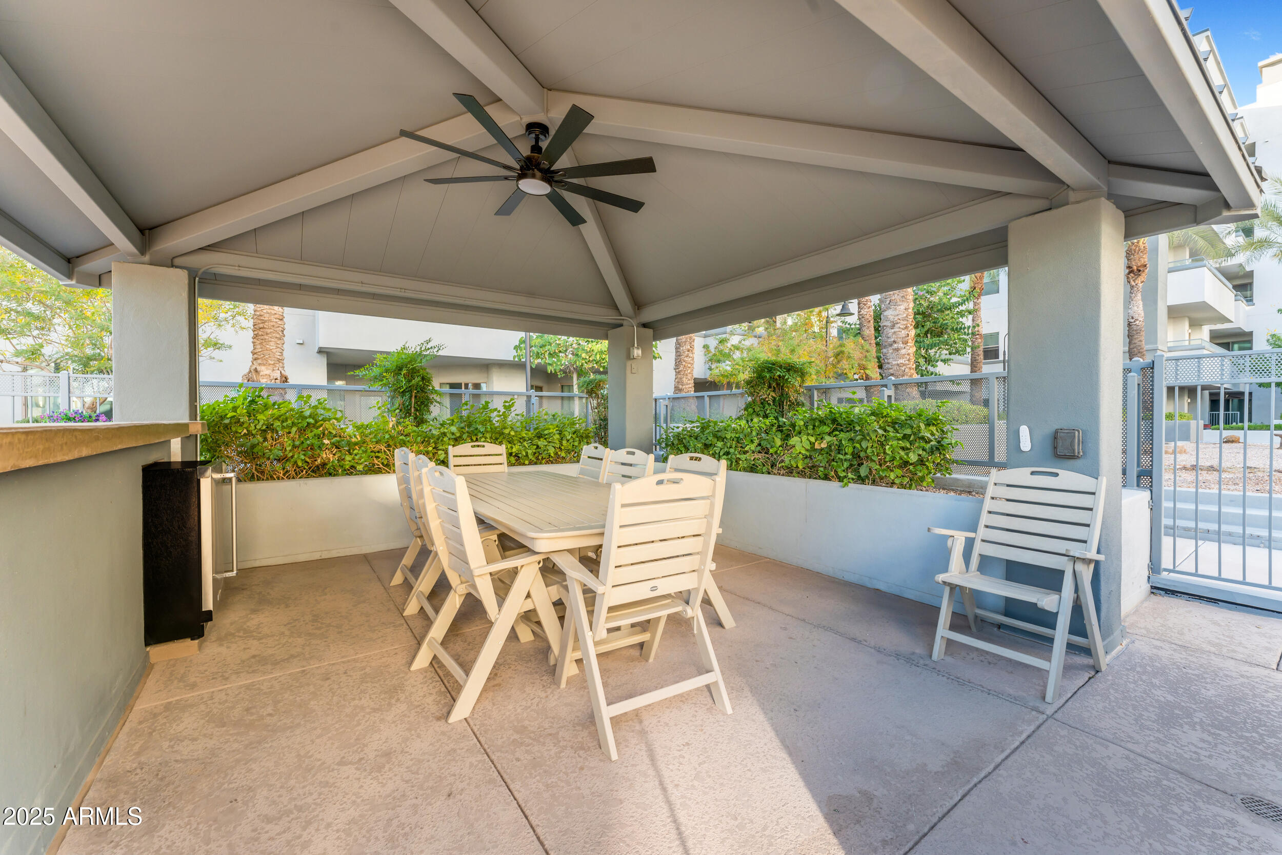 945 East Playa Del Norte Drive, Unit 5005 Tempe, AZ 85288 - Photo 64 of 69 a view of a patio with a table chairs and a backyard