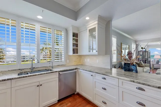 a living room with furniture floor to ceiling window and wooden floor