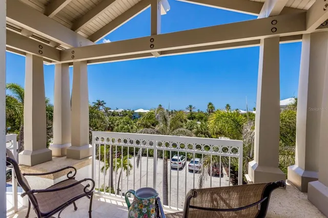 a living room with furniture and floor to ceiling windows