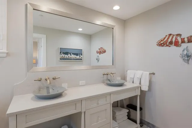 a room with lots of tables a large window and chairs