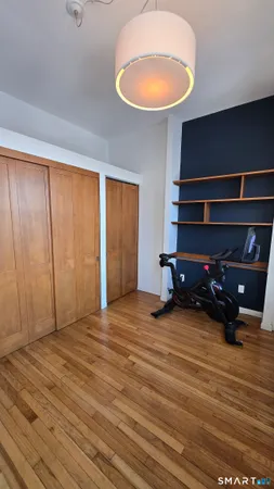 a bedroom with a bed and a night stand