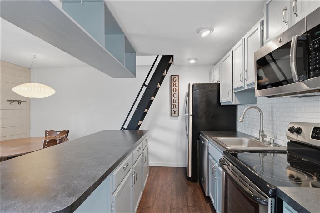 580 Maple Court Hidden Valley, PA 15502 - Photo 6 of 28 a kitchen with stainless steel appliances granite countertop a refrigerator a stove microwave and sink
