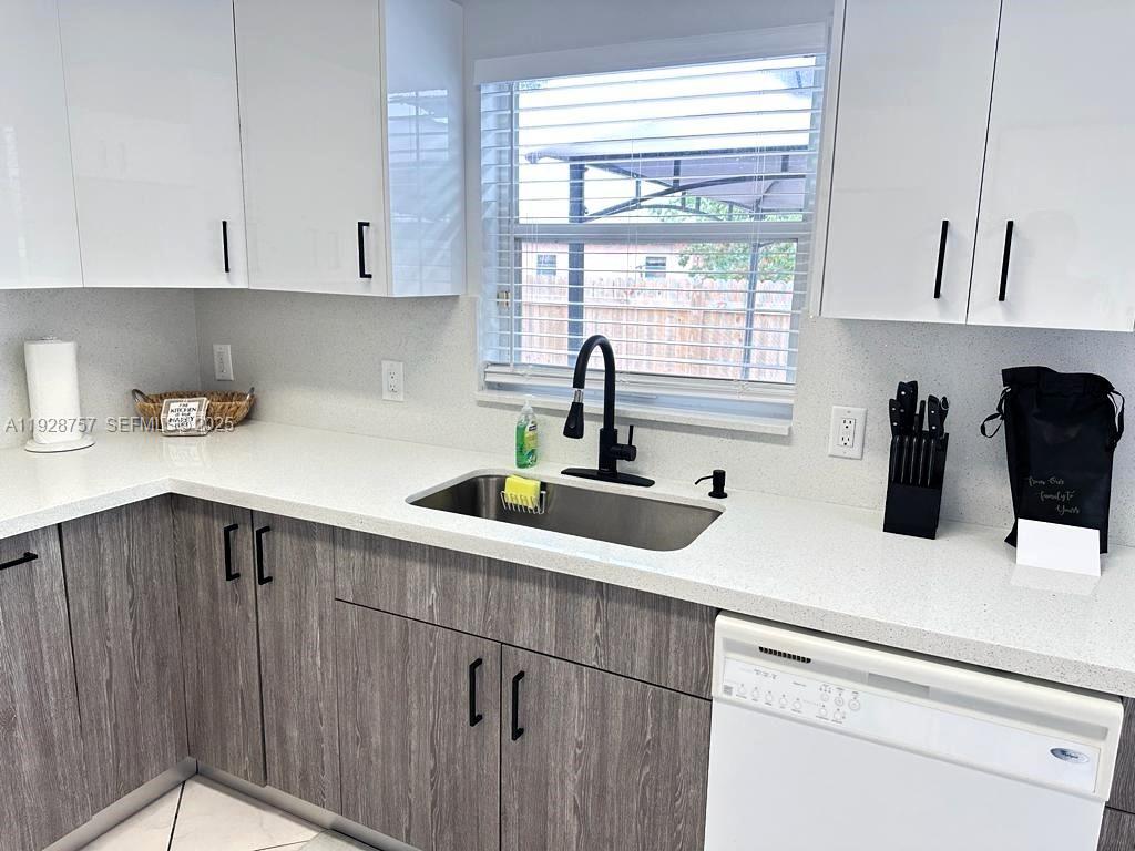 720 2nd Place Southwest Vero Beach, FL 32962 - Photo 21 of 44 a kitchen with a sink a window and cabinets