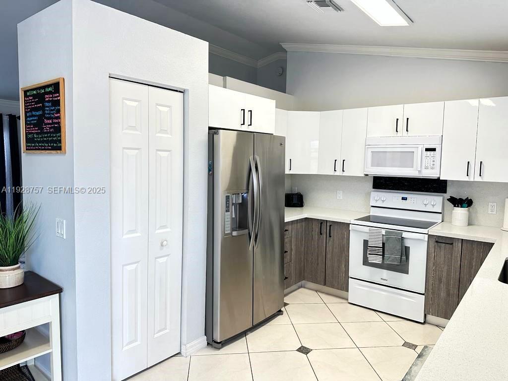 720 2nd Place Southwest Vero Beach, FL 32962 - Photo 22 of 44 a kitchen with stainless steel appliances a refrigerator sink and cabinets
