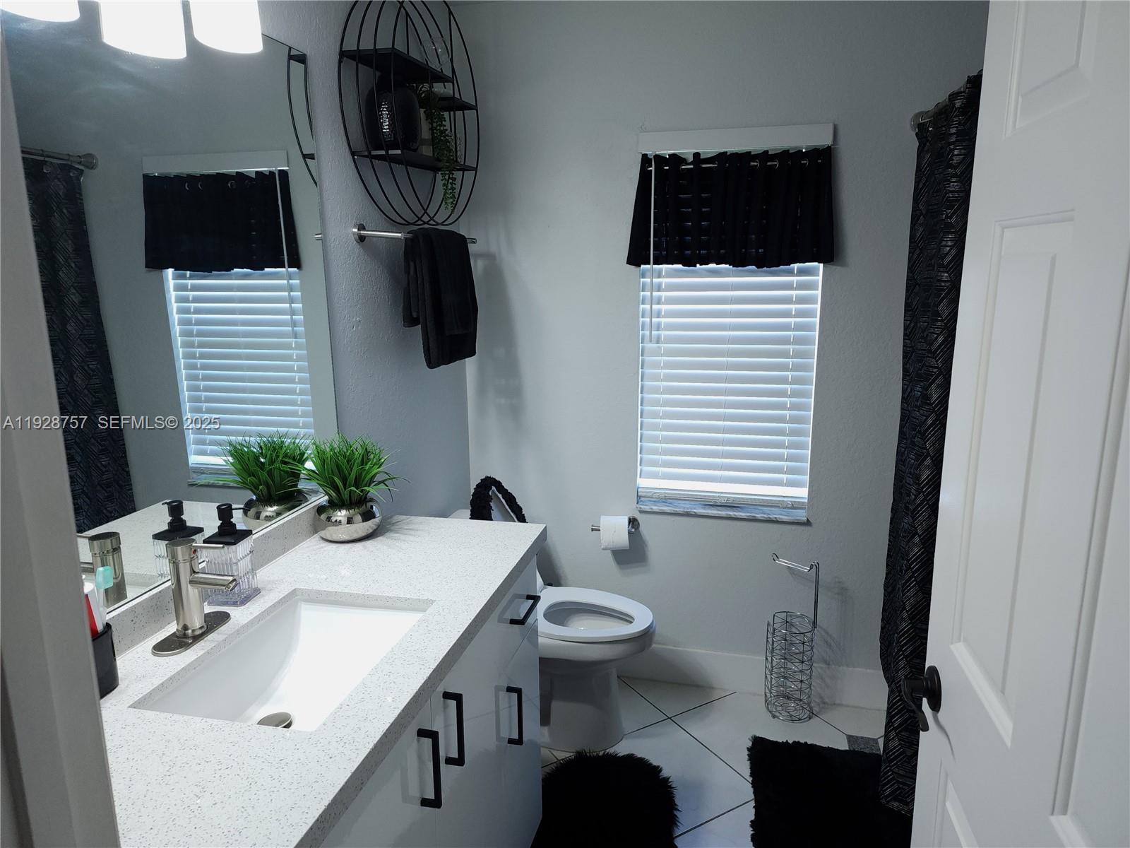 720 2nd Place Southwest Vero Beach, FL 32962 - Photo 28 of 44 a bathroom with a sink toilet and mirror