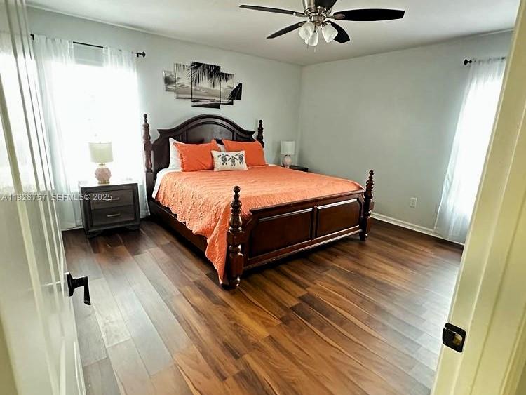 720 2nd Place Southwest Vero Beach, FL 32962 - Photo 32 of 44 a bedroom with a bed and wooden floor