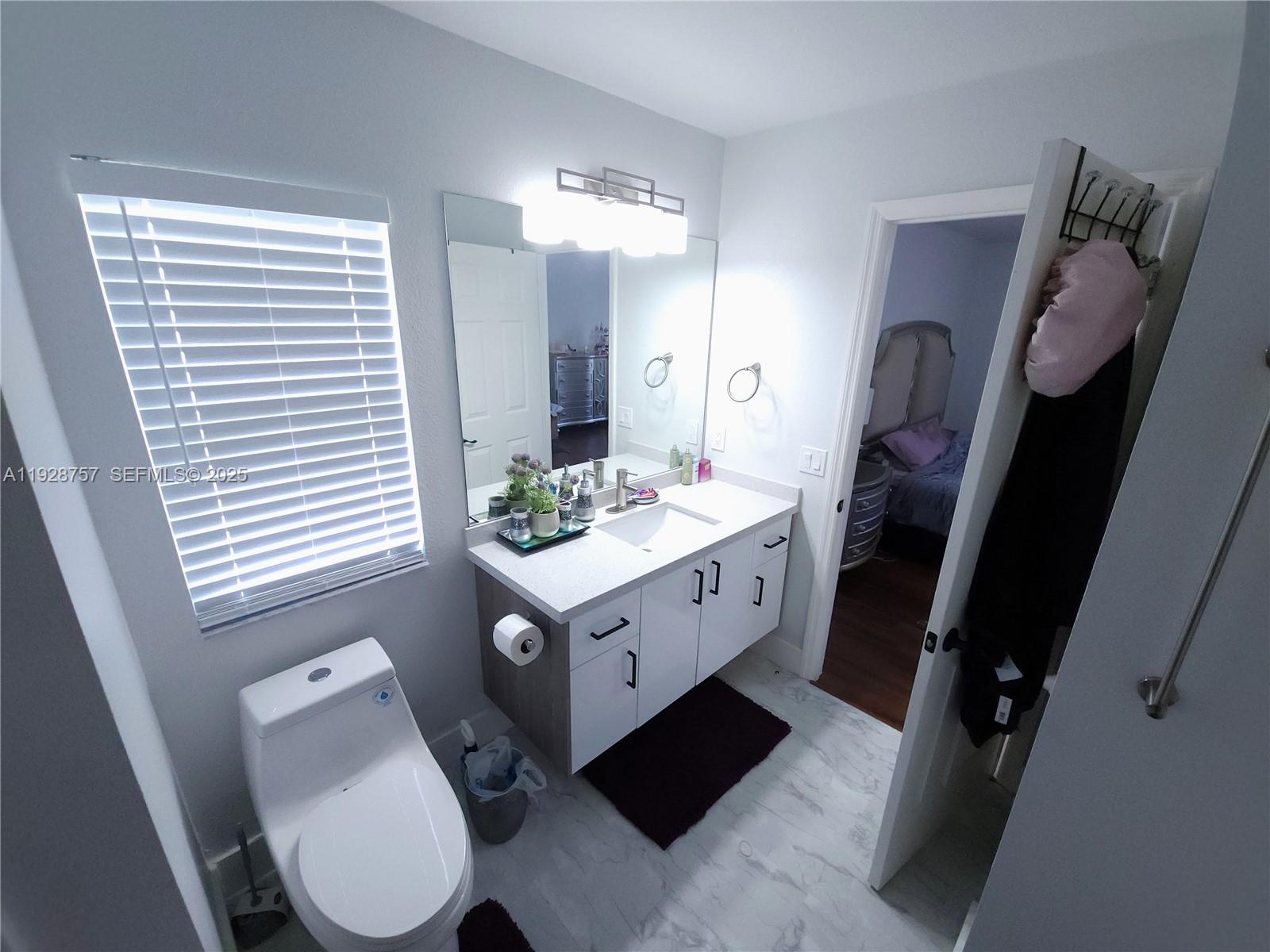 720 2nd Place Southwest Vero Beach, FL 32962 - Photo 36 of 44 a bathroom with a sink a toilet a mirror and shower