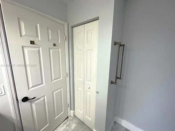 a view of a bathroom from the door