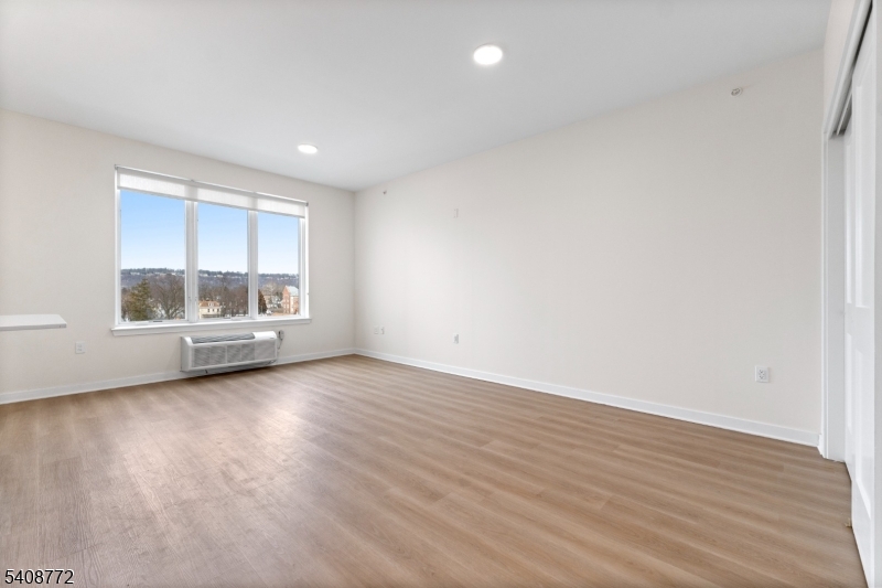 321 East 3rd Street, Unit 525 Plainfield, NJ 07060 - Photo 19 of 43 wooden floor in an empty room with a window