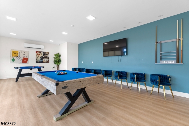 321 East 3rd Street, Unit 525 Plainfield, NJ 07060 - Photo 32 of 43 a living room with furniture pool table and a flat screen tv