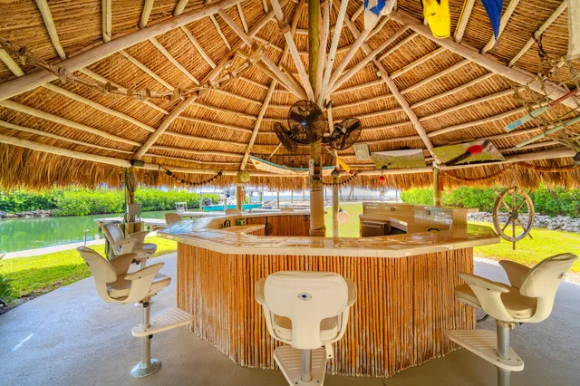 a bedroom with furniture and a large window