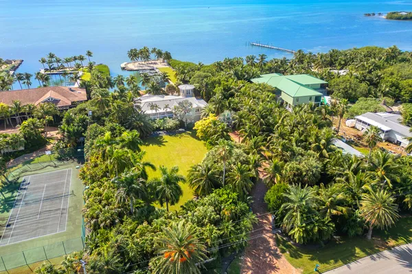 a en suite bathroom with a granite countertop sink and a mirror