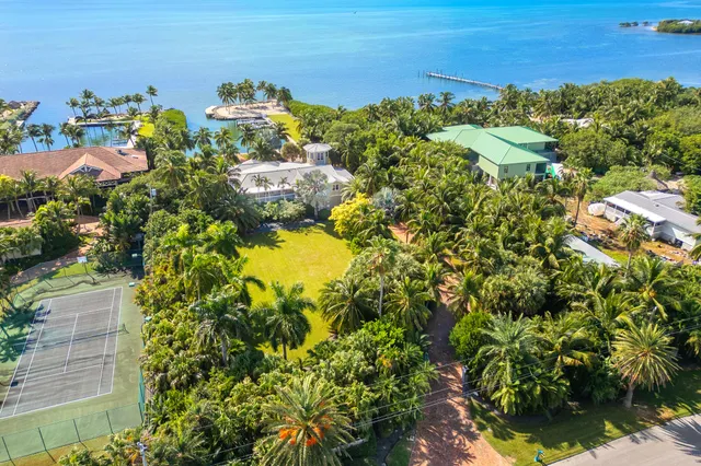 a en suite bathroom with a granite countertop sink and a mirror